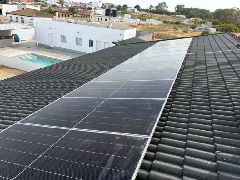 Placas solares en el tejado de una vivienda con piscina